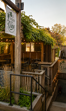 The Under the Vine patio at dusk, string lights on